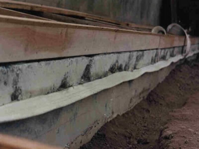 White PVC waterstop is installed in the concrete joint.