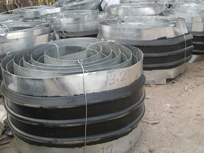 Many rolls of steel-side waterstops are on the ground.