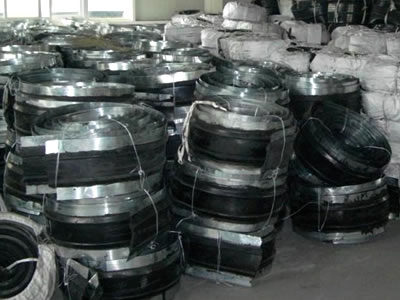 Many rolls of steel-side waterstops are on the ground, and some of them are wrapped with woven bags.